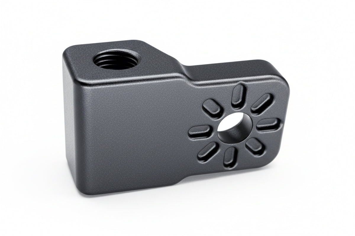 Black metal component with threaded hole and circular pattern on a white background