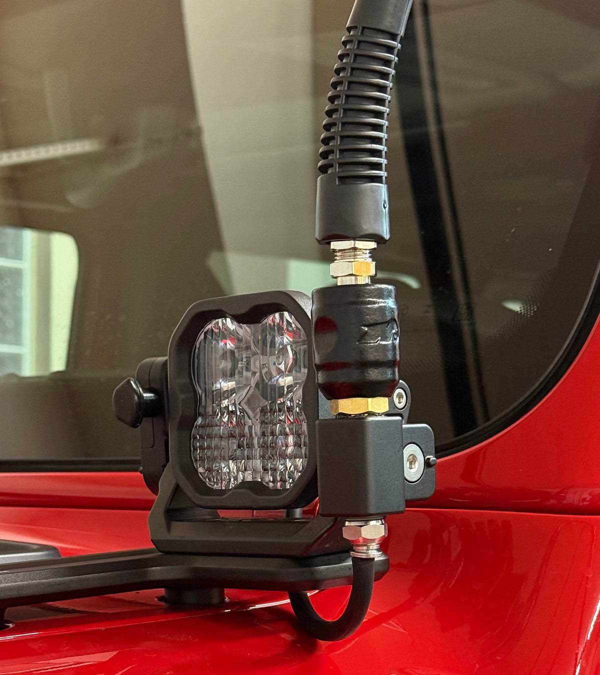 air coupler with air hose, attached to light on red vehicle.