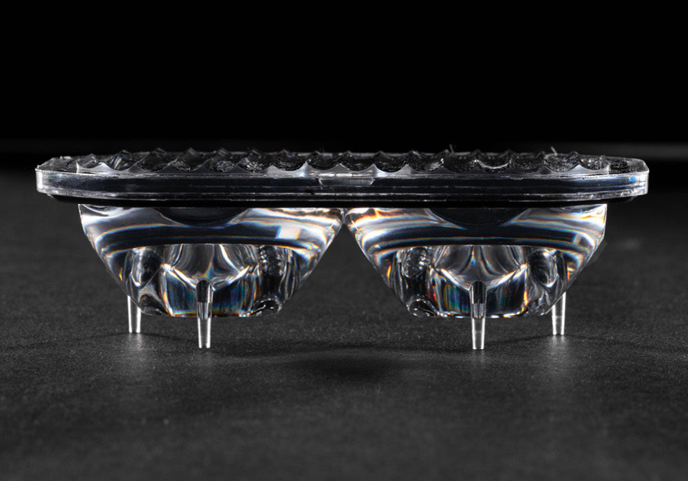 Close-up of light optical lens with a textured surface on a dark background