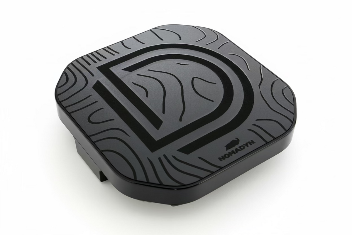 Black light cover with a logo on a textured surface.