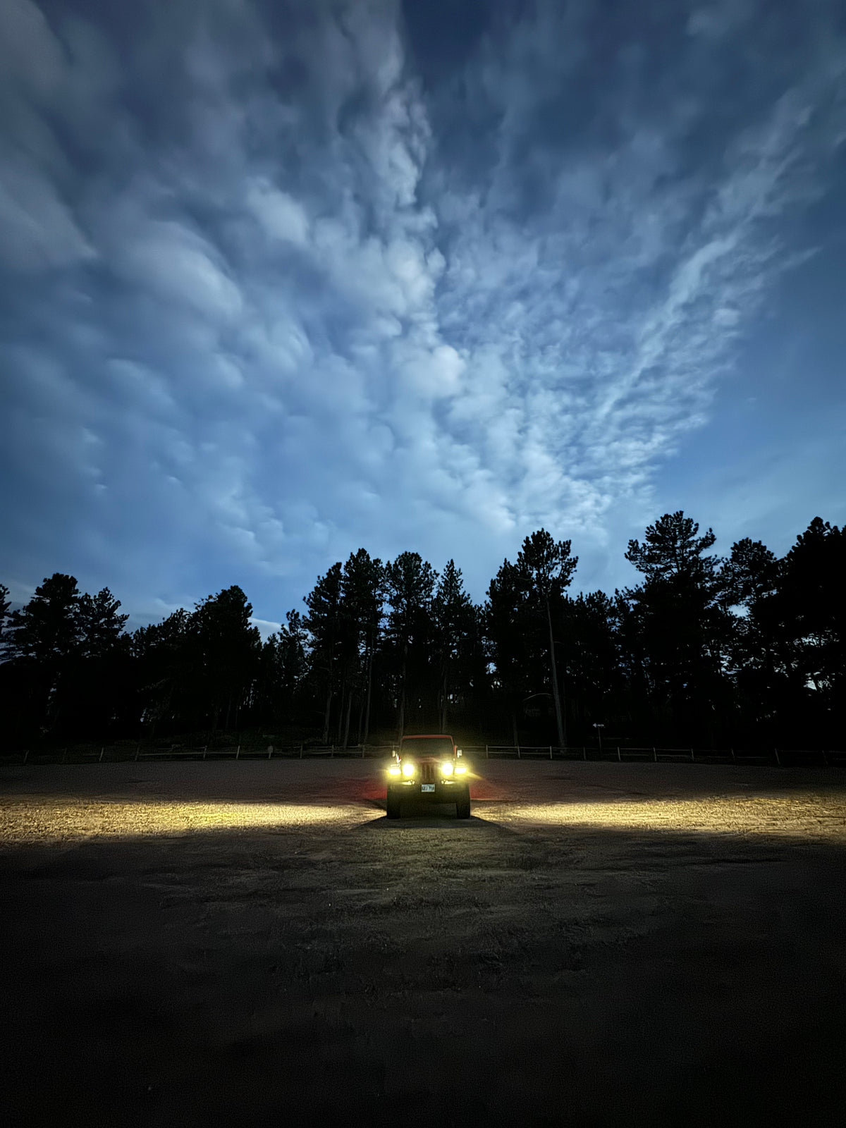 Front view of Jeep at night, with side lighting showing range using flood lenses.