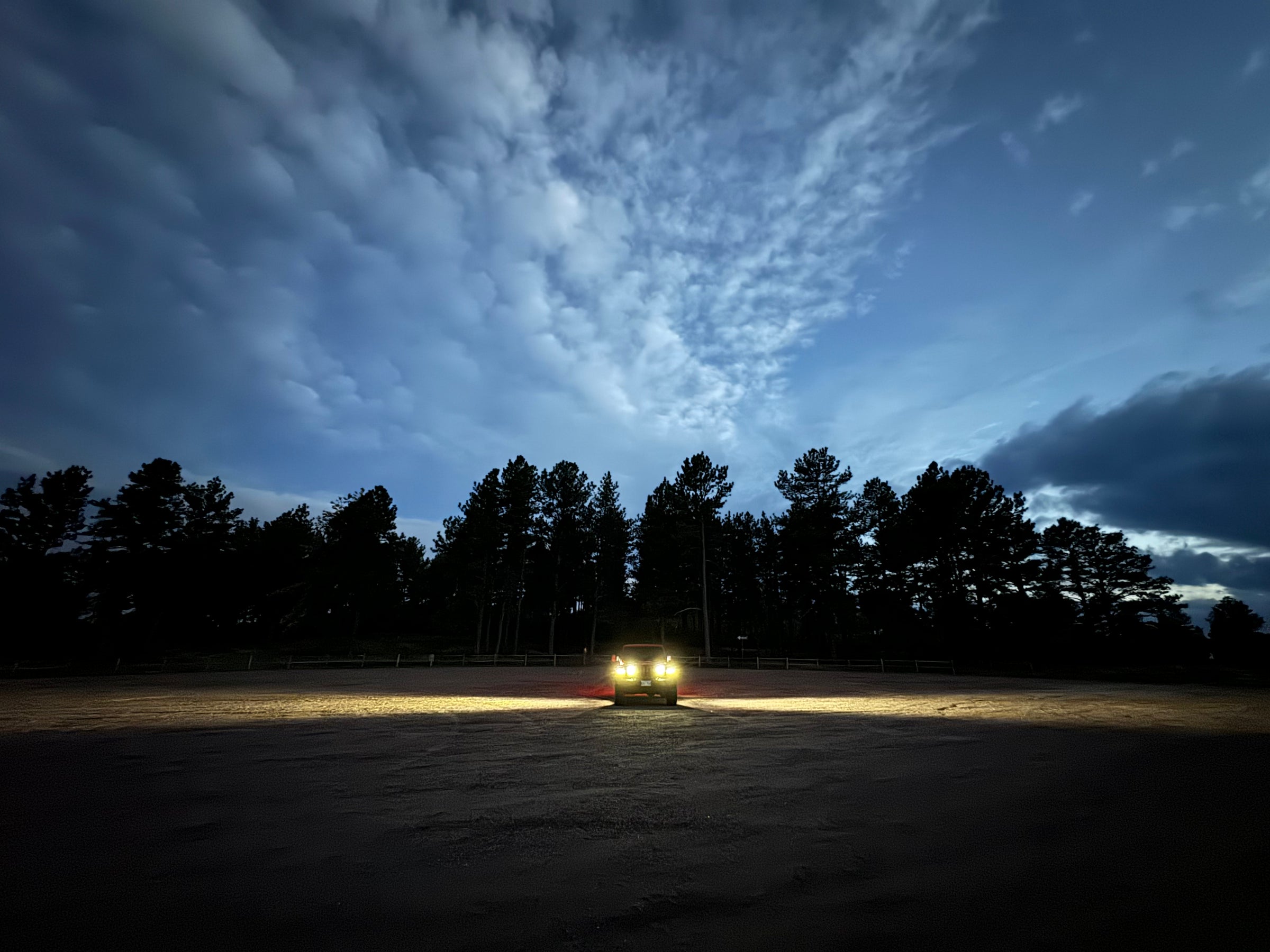 Front view of Jeep at night, with side lighting showing range using flood lenses, wide angle view.