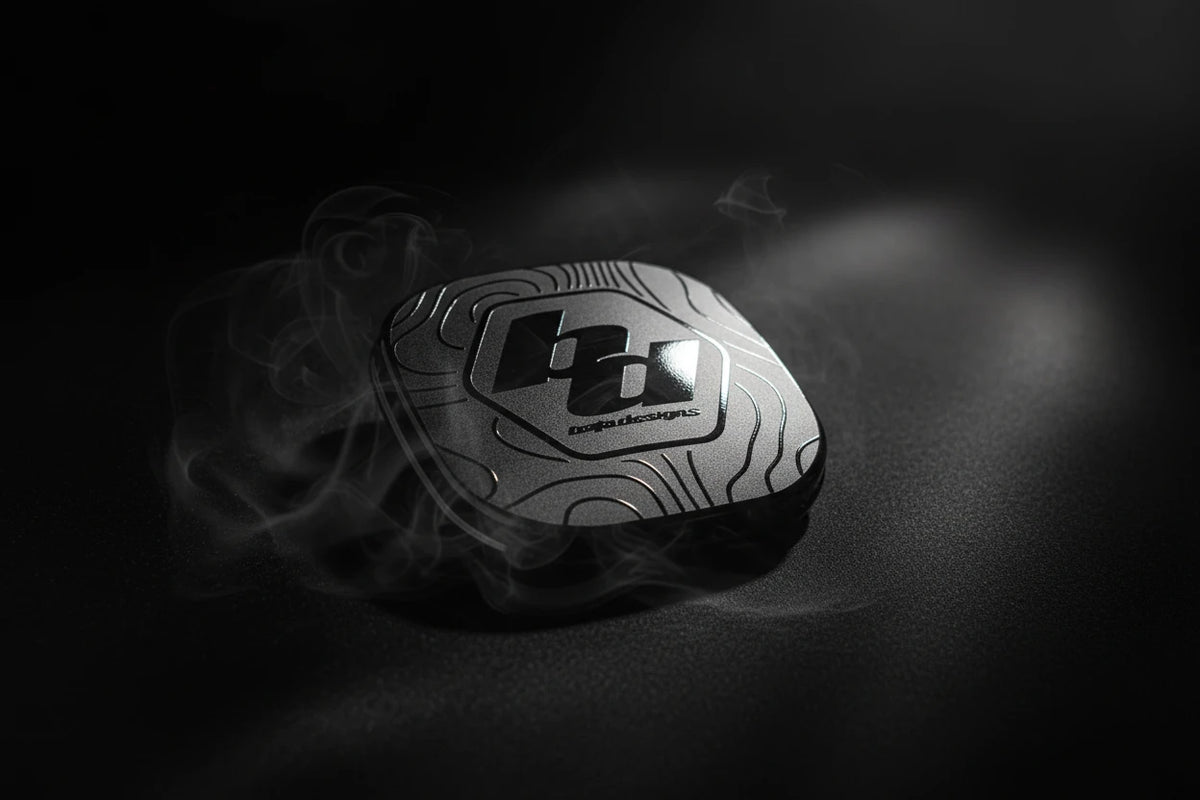 Black textured decal with a logo on a gray surface