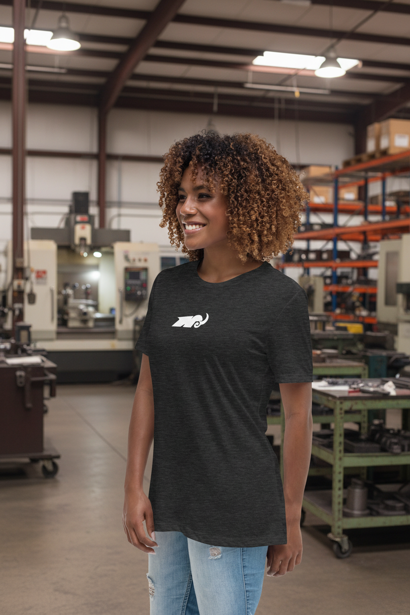 Person wearing a black t-shirt with a logo in an industrial setting
